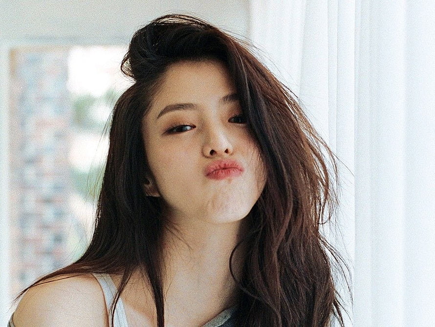 Han So Hee Playful Portrait With Windblown Hair And Soft Natural Light HD wallpaper