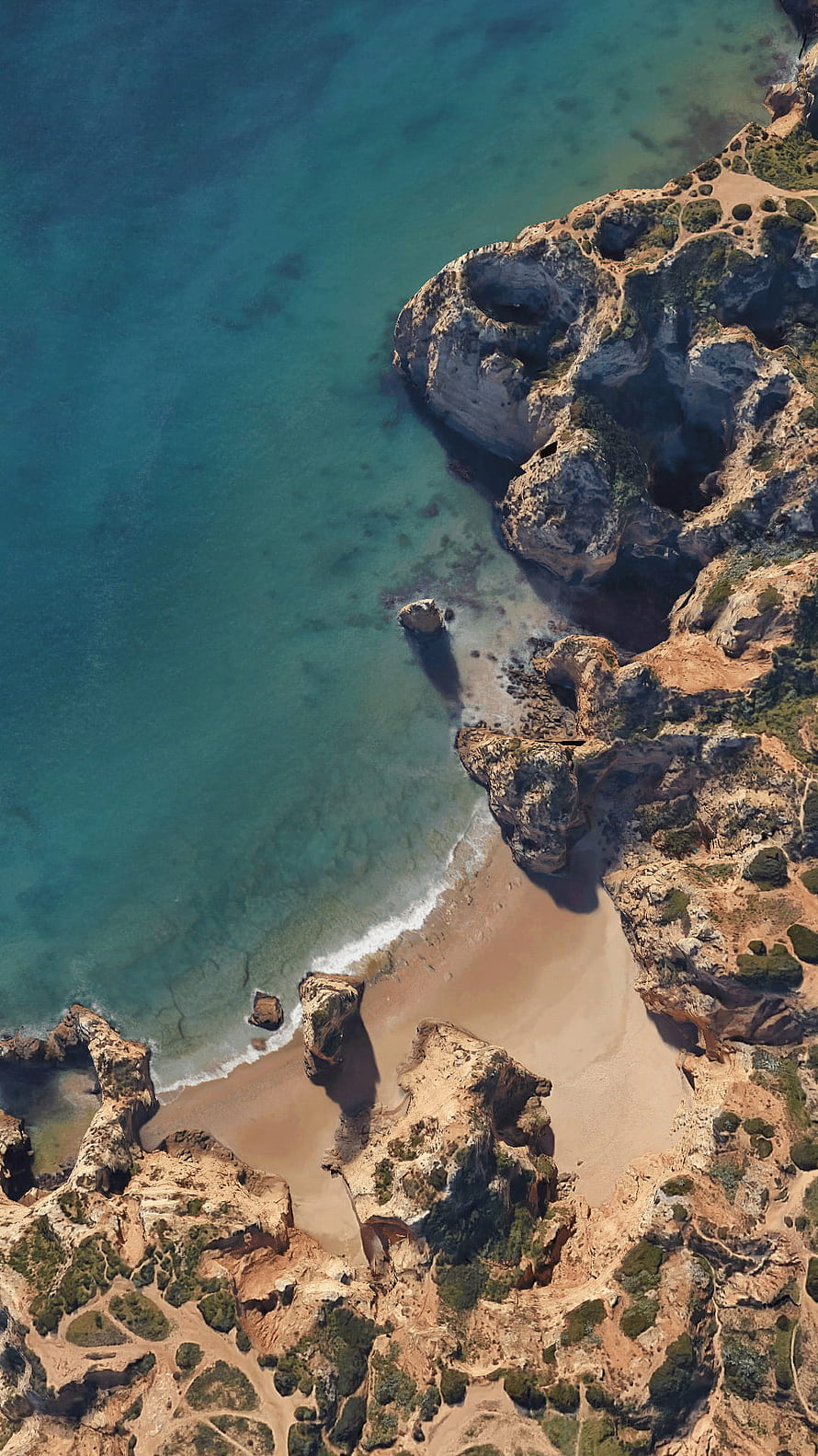 Aerial View of Turquoise Coastline with Rocky Cliffs and Sandy Beach HD phone wallpaper