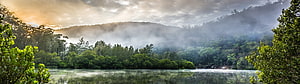 Misty Forest Lake at Sunrise with Sunbeams Through Clouds HD wallpaper