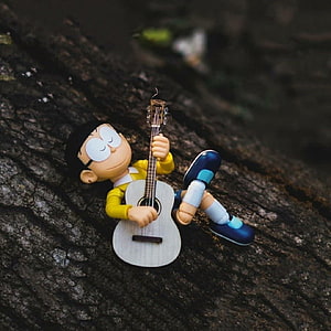 Nobita Nobi Reclining on Tree Bark with Acoustic Guitar in Cozy Outdoor Setting HD phone wallpaper