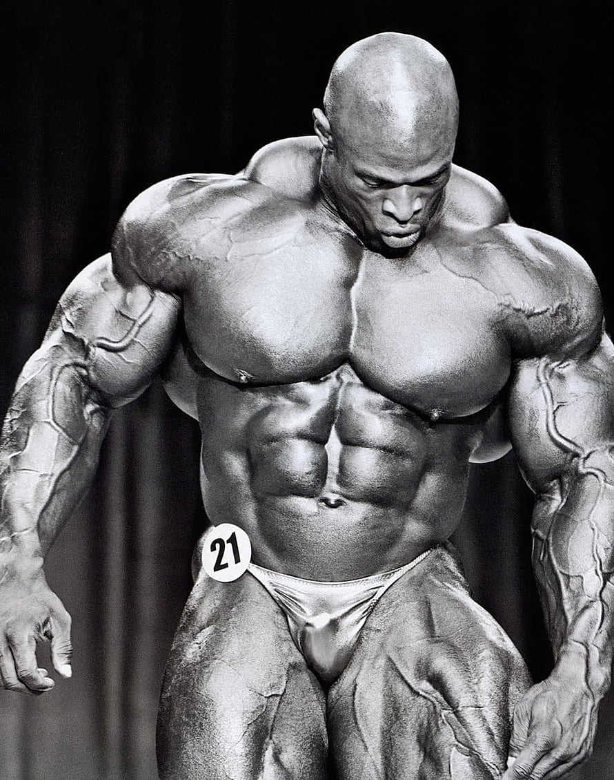 Black and white photo of a massive bodybuilder posing on stage with extreme muscle definition and vascularity HD phone wallpaper