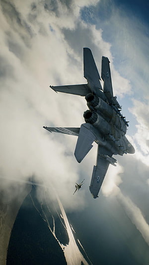 McDonnell Douglas F-15E Strike Eagle in dramatic low-altitude flight with skydiver HD phone wallpaper