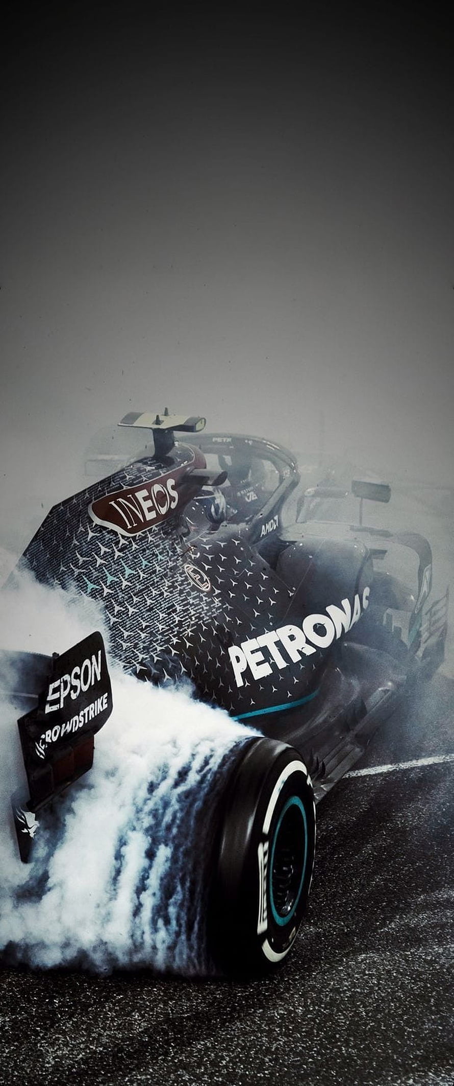 Mercedes F1 Petronas car drifting on wet track with tire smoke HD phone wallpaper