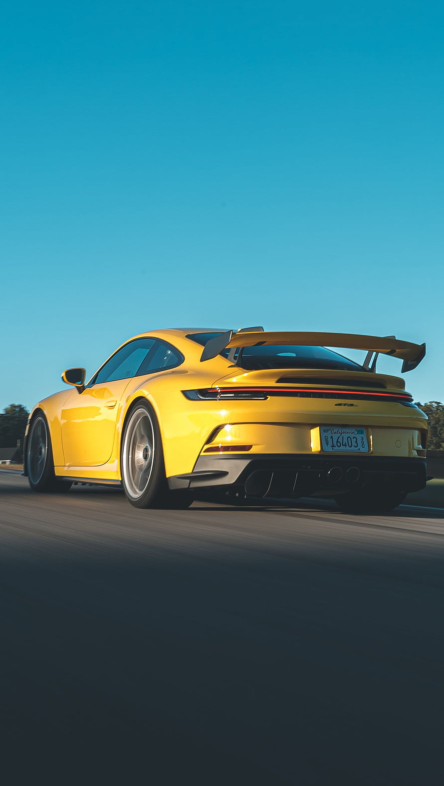 Yellow Porsche 911 GT3 RS Driving on Highway with Blue Sky Background HD phone wallpaper