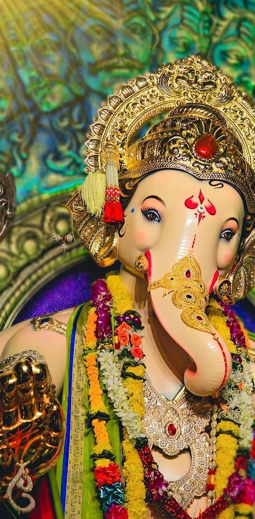 Ganesha Idol With Golden Crown And Flower Garlands HD phone wallpaper