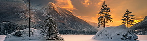 Serene Winter Mountain Landscape with Snowy Pines and Golden Sunset HD wallpaper