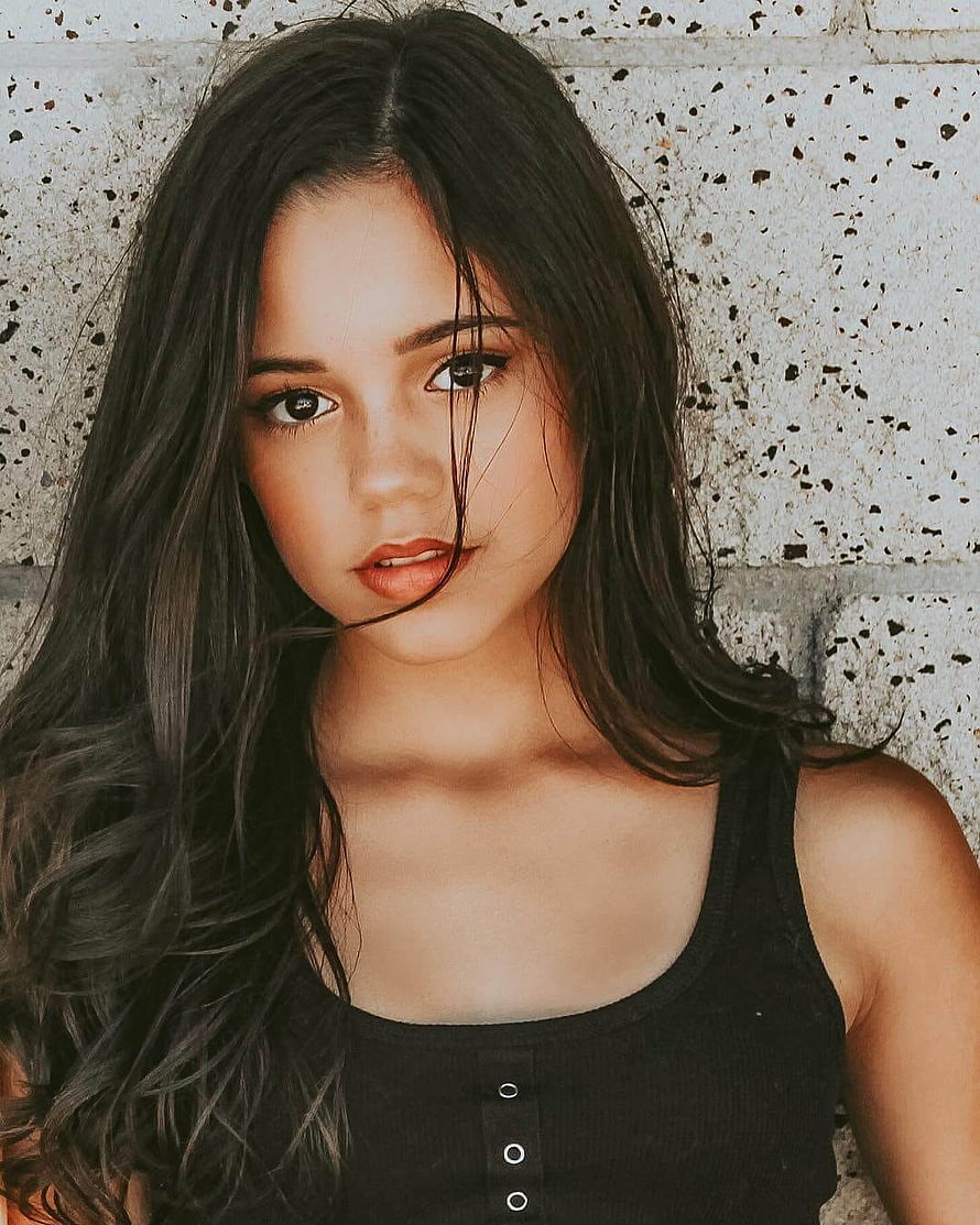 Jenna Ortega Portrait Against Textured Concrete Wall HD phone wallpaper