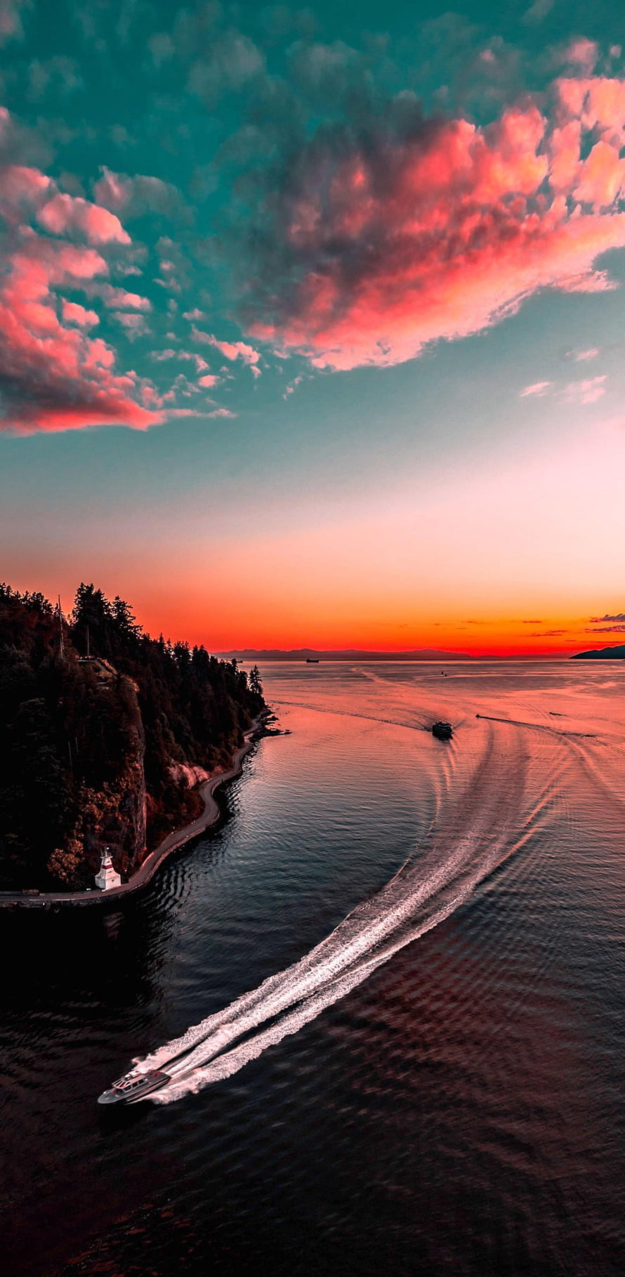 Aerial View of Speedboat Leaving Wake on Ocean at Sunset with Lighthouse HD phone wallpaper