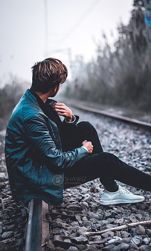 Man in Teal Leather Jacket Sitting on Train Tracks, Boys dp, sad pose boy HD phone wallpaper