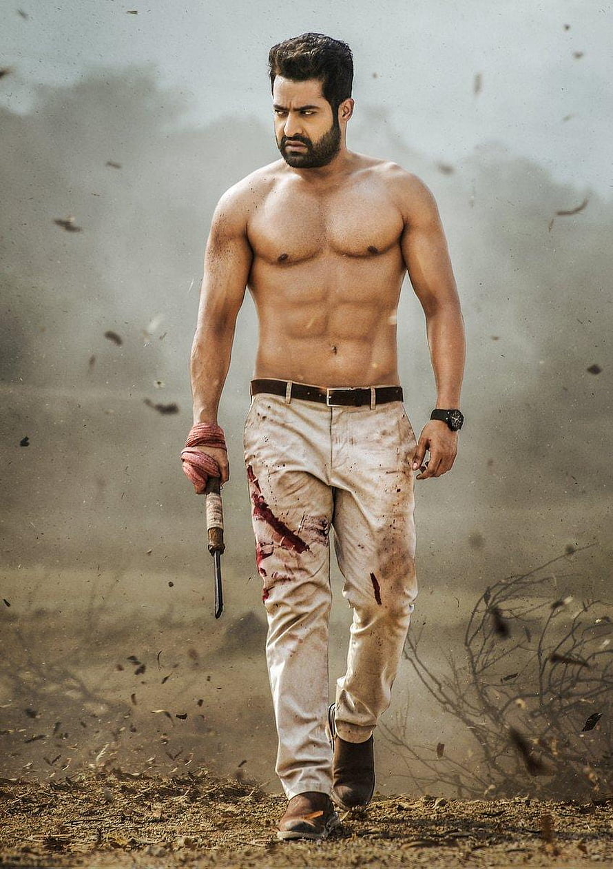 Veera Raghava Action Hero Walking Through Dusty Battlefield Holding Dagger HD phone wallpaper