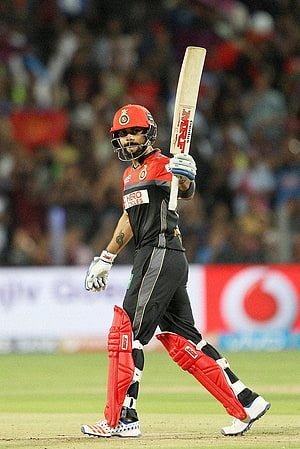 Virat Kohli in Royal Challengers Bangalore kit holding cricket bat during IPL match HD phone wallpaper