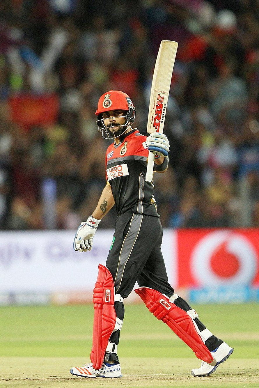 Virat Kohli in Royal Challengers Bangalore kit holding cricket bat during IPL match HD phone wallpaper