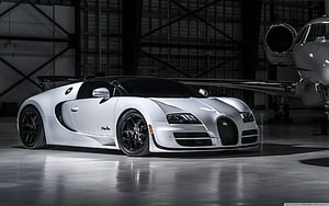 White Bugatti Veyron Super Sport parked in a hangar with a private jet in the background HD wallpaper