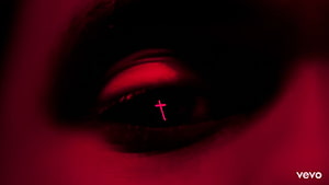 Close-up of a human eye with a glowing red cross reflection in the pupil, set against a dark crimson background with a mysterious and intense atmosphere, the weeknd starboy, #The Weeknd HD wallpaper