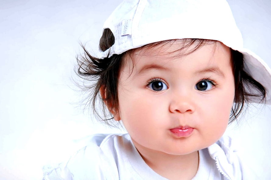 Cute Baby Wearing White Cap With Big Eyes And Pouty Lips Portrait HD wallpaper