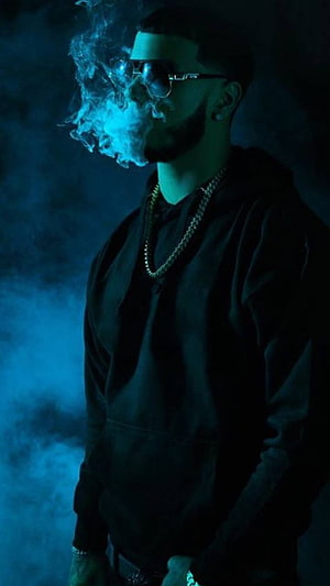 Drake smoking with blue smoke in dark hoodie and sunglasses HD phone wallpaper