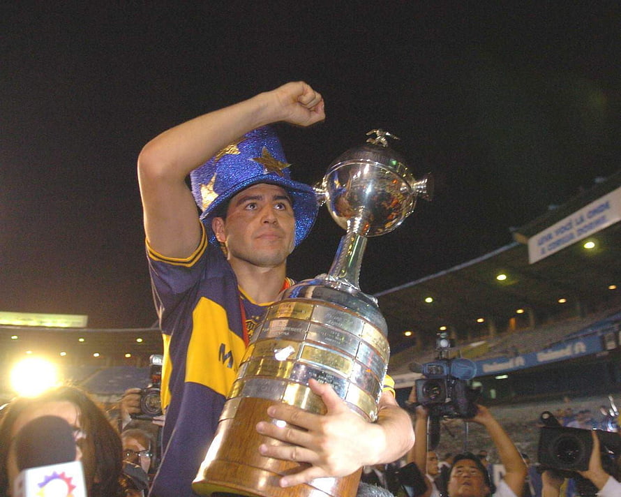 Juan Roman Riquelme of Boca Juniors lifting the Copa Libertadores trophy in a stadium celebration, Juan Roman Riquelme riquelme boca juniors and, #riquelme HD wallpaper