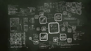 Hand-drawn UI wireframe and app icon concept sketches on a dark chalkboard background HD wallpaper