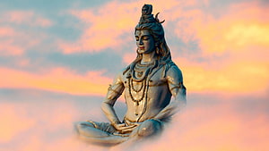 Serene Statue of Lord Shiva Meditating in Lotus Pose Against a Sunset Sky HD wallpaper