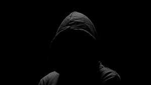 Mysterious Hooded Figure in Darkness HD wallpaper