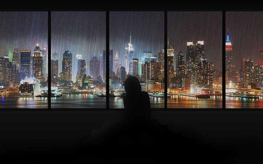 Silhouette of a person gazing at a rainy New York City skyline at night through a large window HD wallpaper