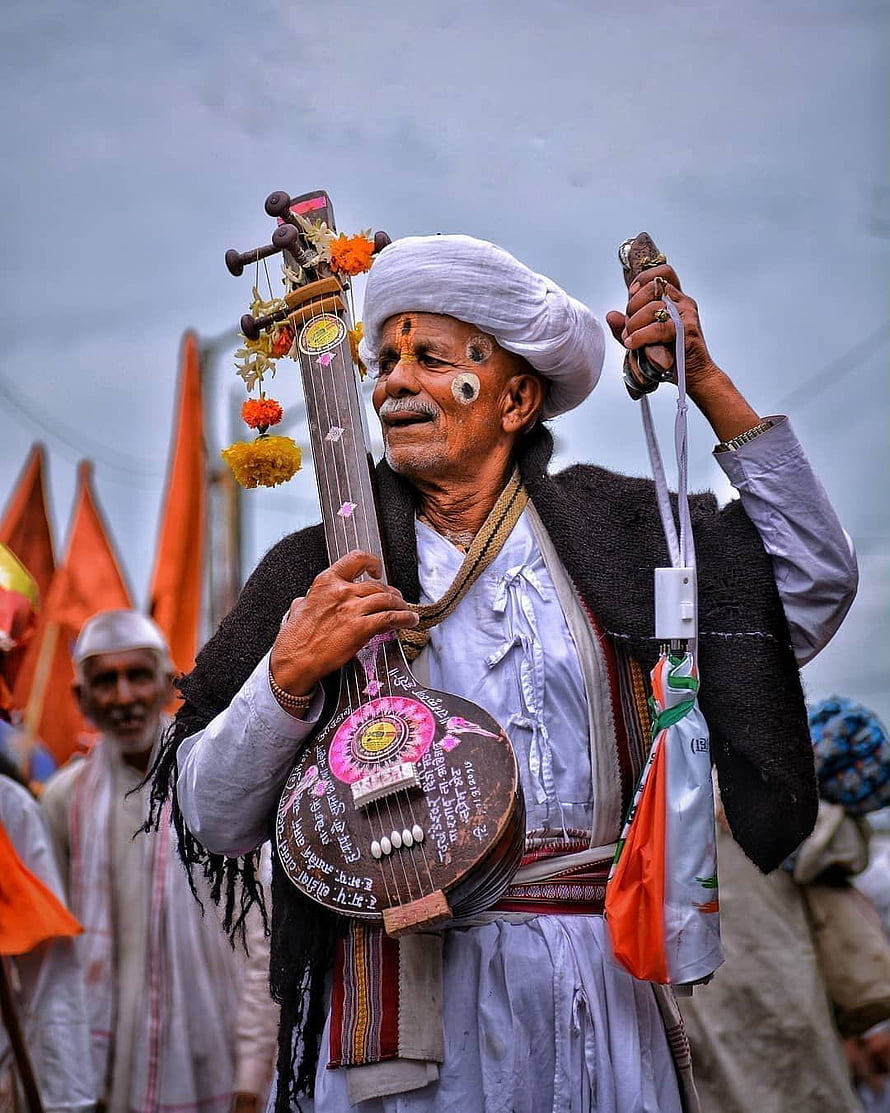 Elderly Varkari Devotee Holding Decorated Tanpura at Religious Gathering HD phone wallpaper