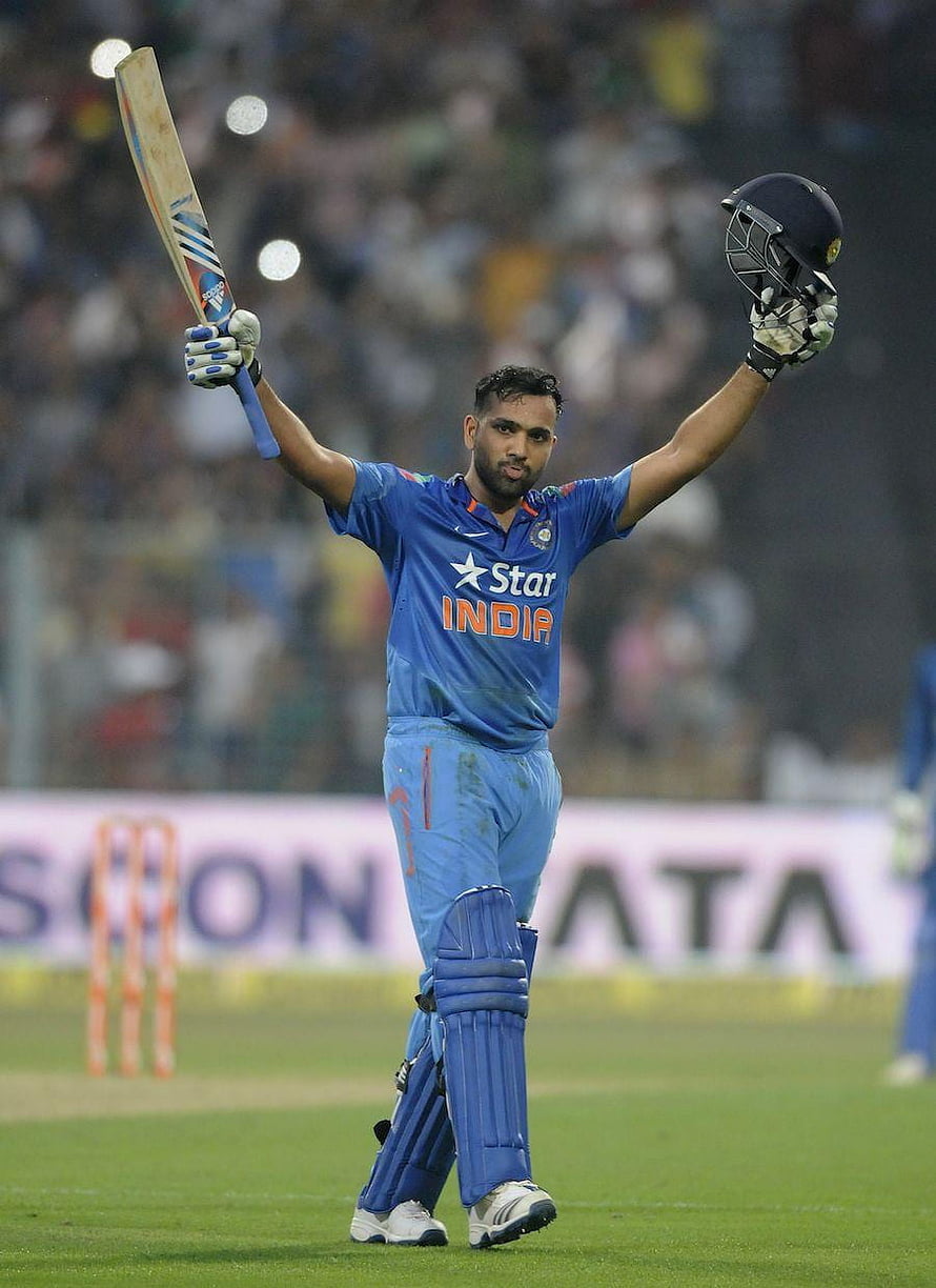 Indian cricketer Rohit Sharma celebrates a century with bat and helmet raised HD phone wallpaper
