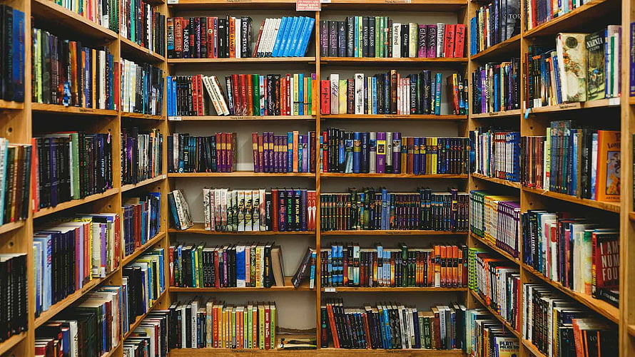 Colorful Wooden Bookshelves Filled With Books In A Library HD wallpaper