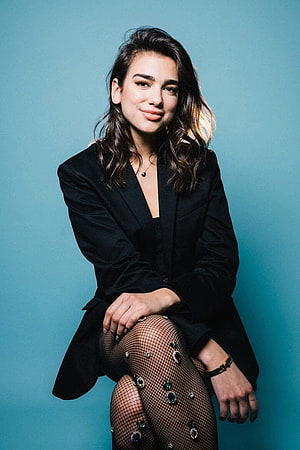 Dua Lipa in Black Blazer and Embellished Fishnet Tights Against Teal Background HD phone wallpaper
