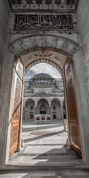 Blue Mosque Istanbul View Through Ornate Marble Archway and Wooden Doors HD phone wallpaper