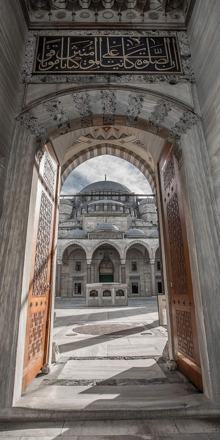 Blue Mosque Istanbul View Through Ornate Marble Archway and Wooden Doors HD phone wallpaper