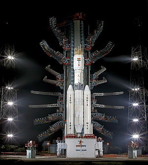 ISRO GSLV rocket on launch pad at night with floodlights and service tower HD phone wallpaper