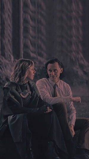 Loki and Sylvie Sitting Together in a Dark Forest Scene HD phone wallpaper