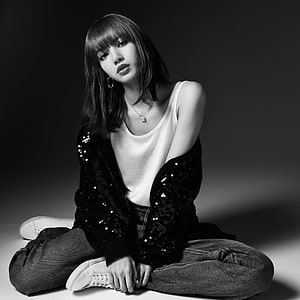 Lisa from Blackpink in a monochrome studio portrait wearing a sequined cardigan and white sneakers HD phone wallpaper