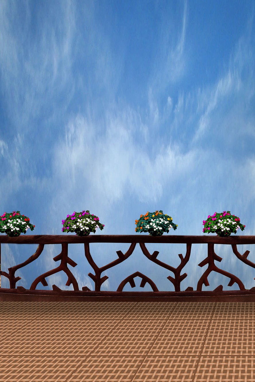 Ornate Balcony Railing with Colorful Flower Boxes Against a Bright Blue Sky HD phone wallpaper