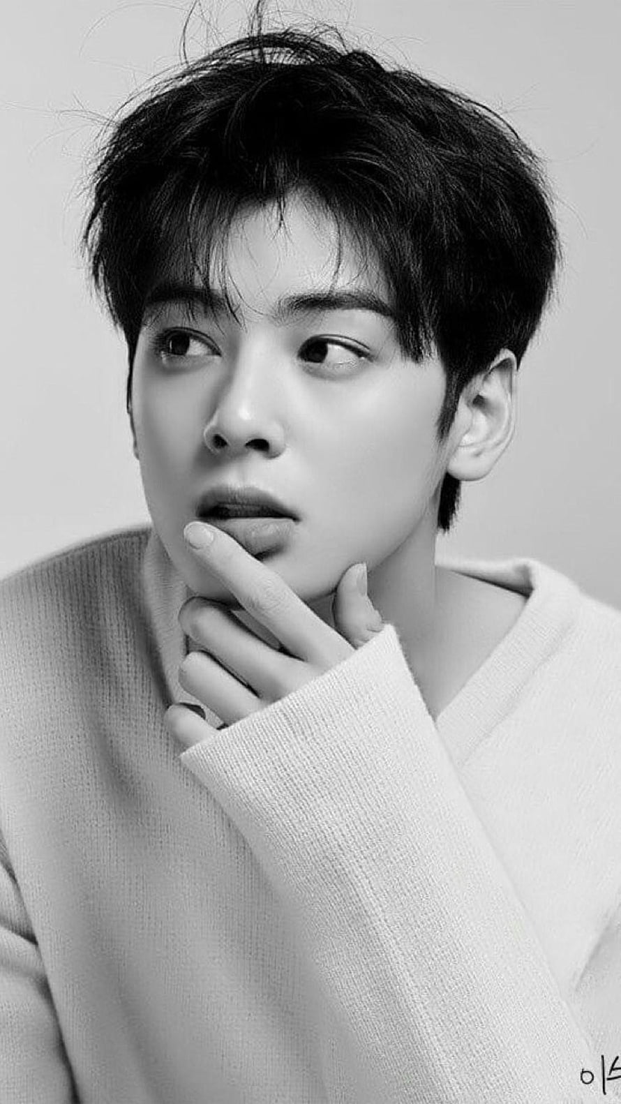 Carat K-pop idol in a black and white portrait wearing a cozy sweater with a thoughtful expression HD phone wallpaper
