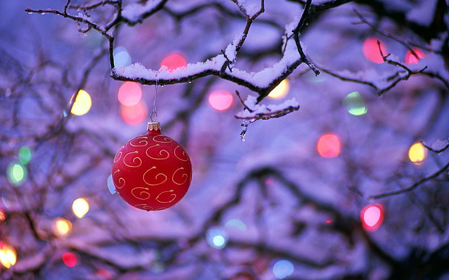 Red Christmas Ornament Hanging on Snowy Branch with Bokeh Lights HD wallpaper