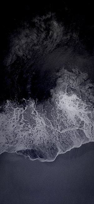 Aerial View of Dark Ocean Waves Crashing on Shore in Monochrome HD phone wallpaper