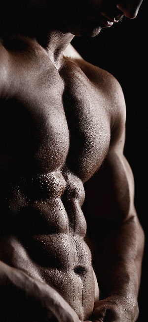 Dramatic Close-Up of a Sweating Muscular Male Torso in Low Light HD phone wallpaper