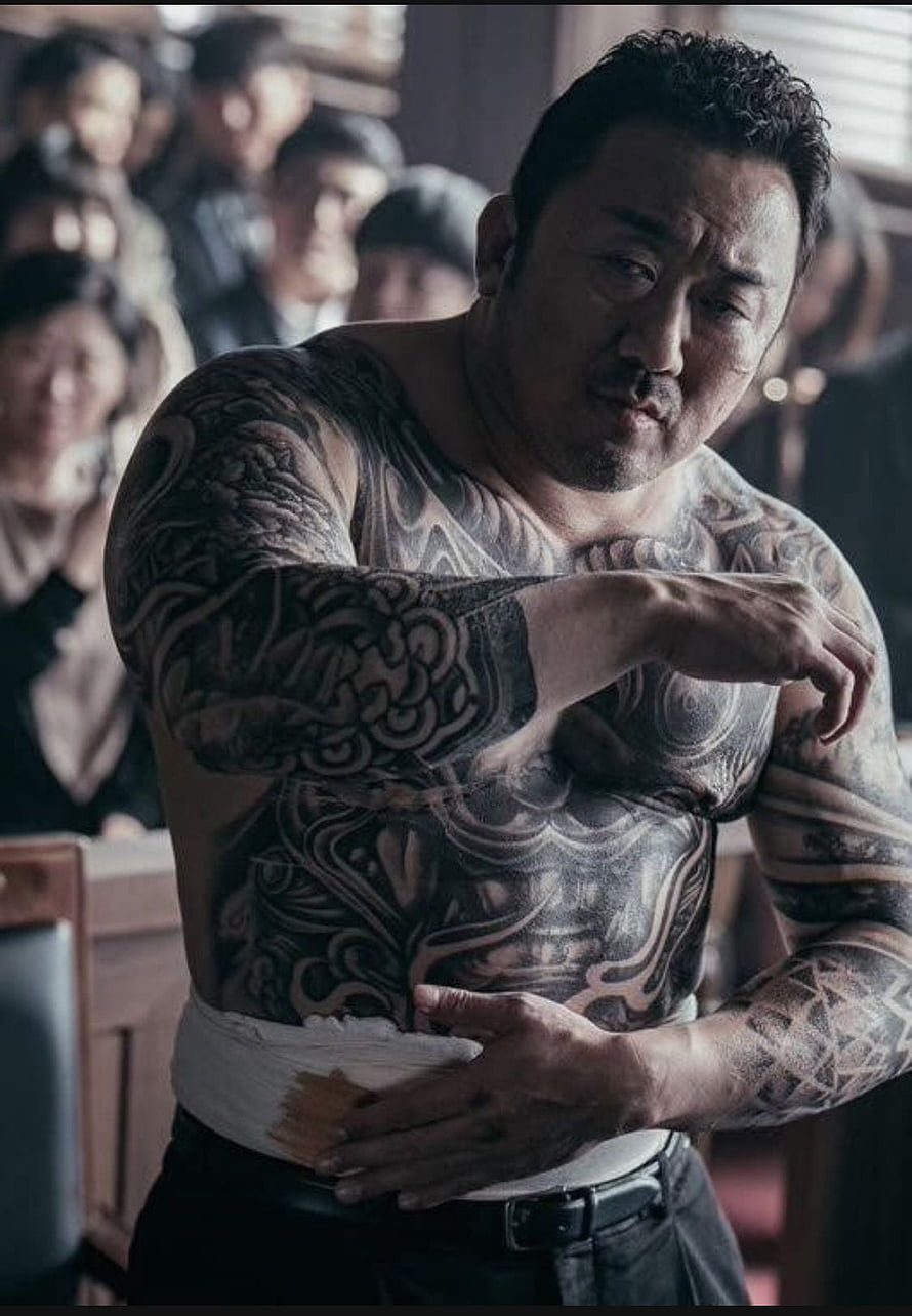 Ma Dong-seok shirtless with full body tattoos and bandaged waist in gritty movie scene HD phone wallpaper