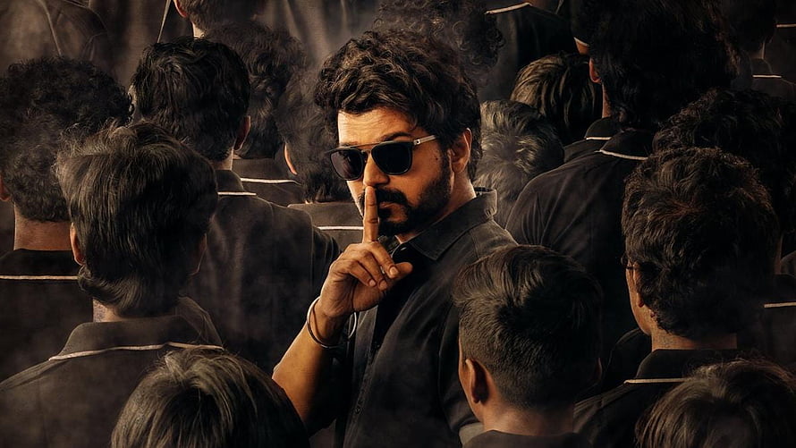 Vijay in Master movie poster making a shushing gesture to a crowd in dark prison uniforms HD wallpaper