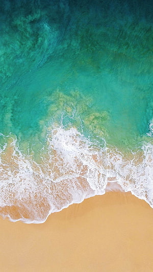 Aerial View of Turquoise Ocean Waves Crashing on Golden Sandy Beach HD phone wallpaper