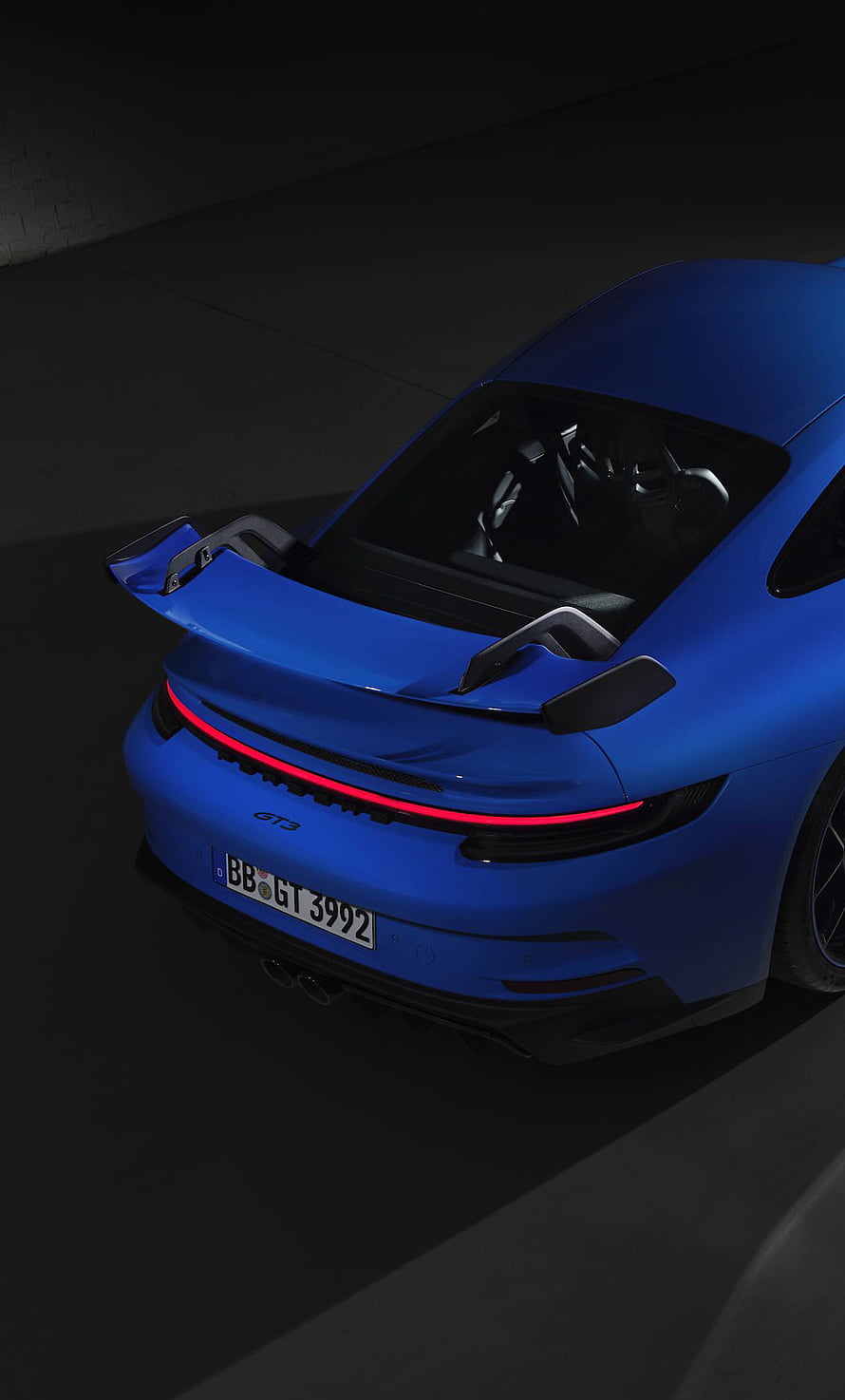 Rear View of Blue Porsche 911 GT3 with Active Spoiler and Red Light Bar HD phone wallpaper