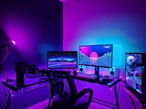Neon Purple and Blue Gaming Setup with Retro Synthwave Wallpapers and RGB Lighting HD wallpaper