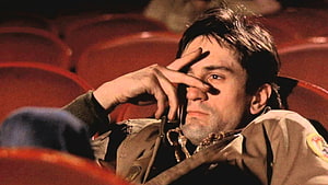 Taxi Driver Movie Scene Featuring Robert De Niro in a Dimly Lit Theater HD wallpaper