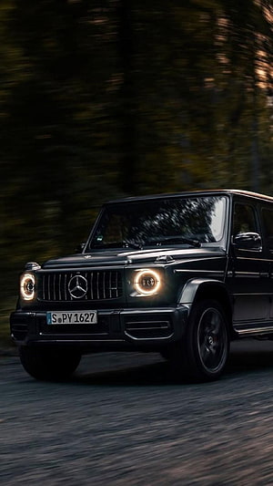 Black Mercedes-Benz G-Class SUV Driving on Forest Road HD phone wallpaper