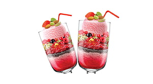 Two glasses of layered falooda dessert topped with fresh berries, nuts, and a red straw on a white background HD wallpaper