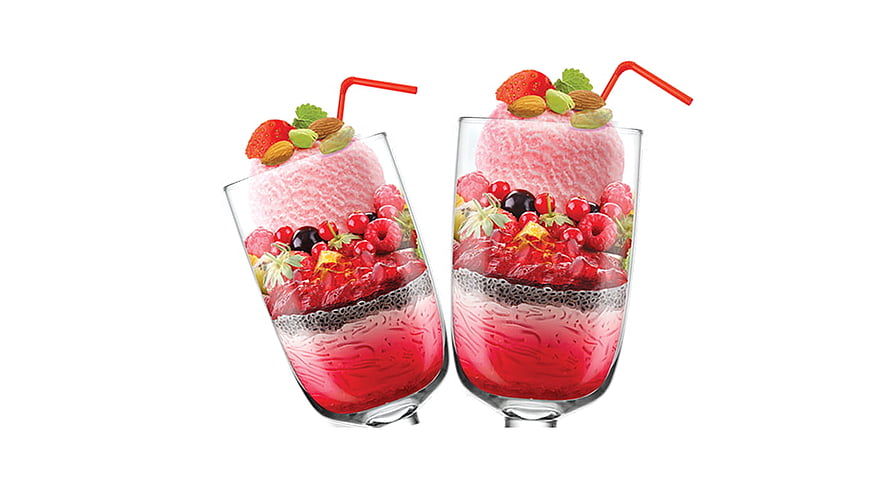Two glasses of layered falooda dessert topped with fresh berries, nuts, and a red straw on a white background HD wallpaper
