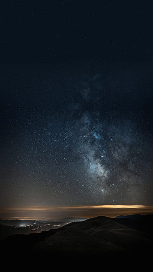Milky Way Galaxy Arching Over Dark Mountain Ridges at Night HD phone wallpaper