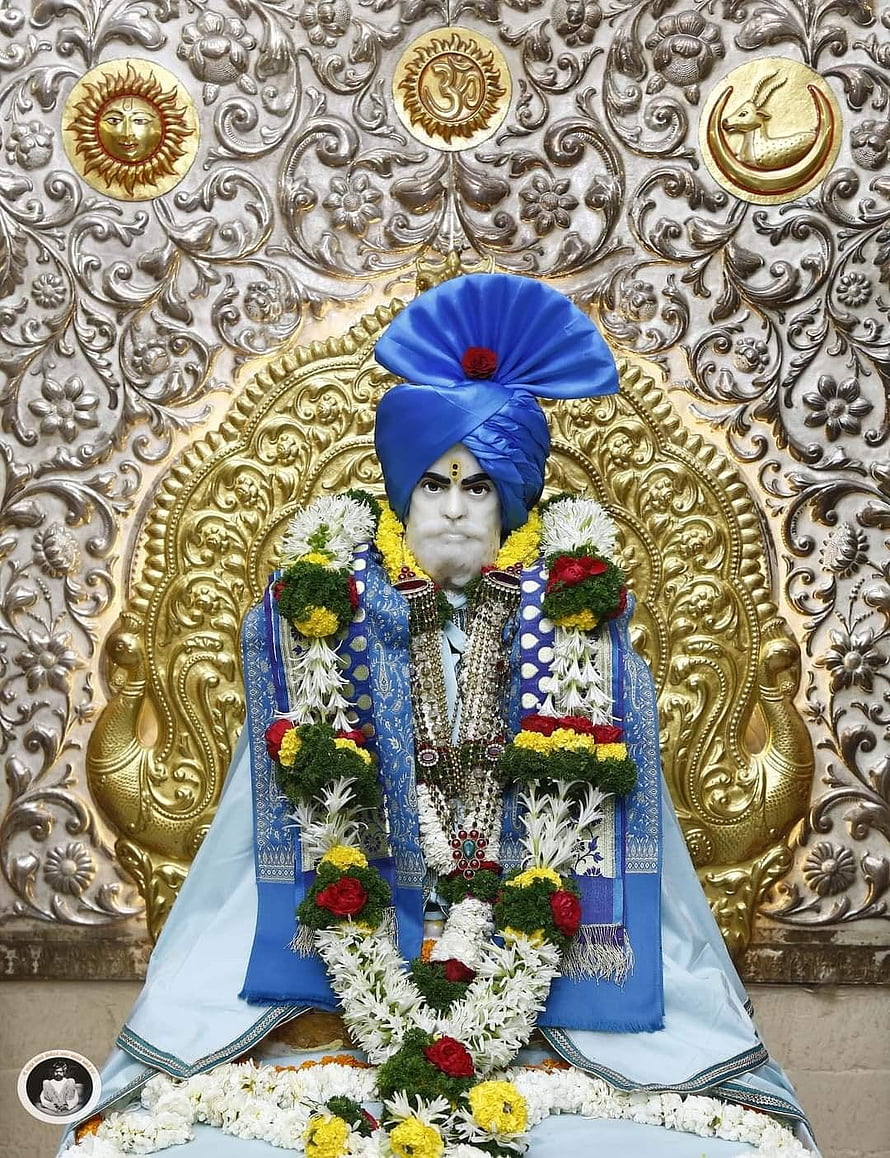 Shankar Maharaj adorned in blue turban and floral garlands against ornate gold backdrop HD phone wallpaper
